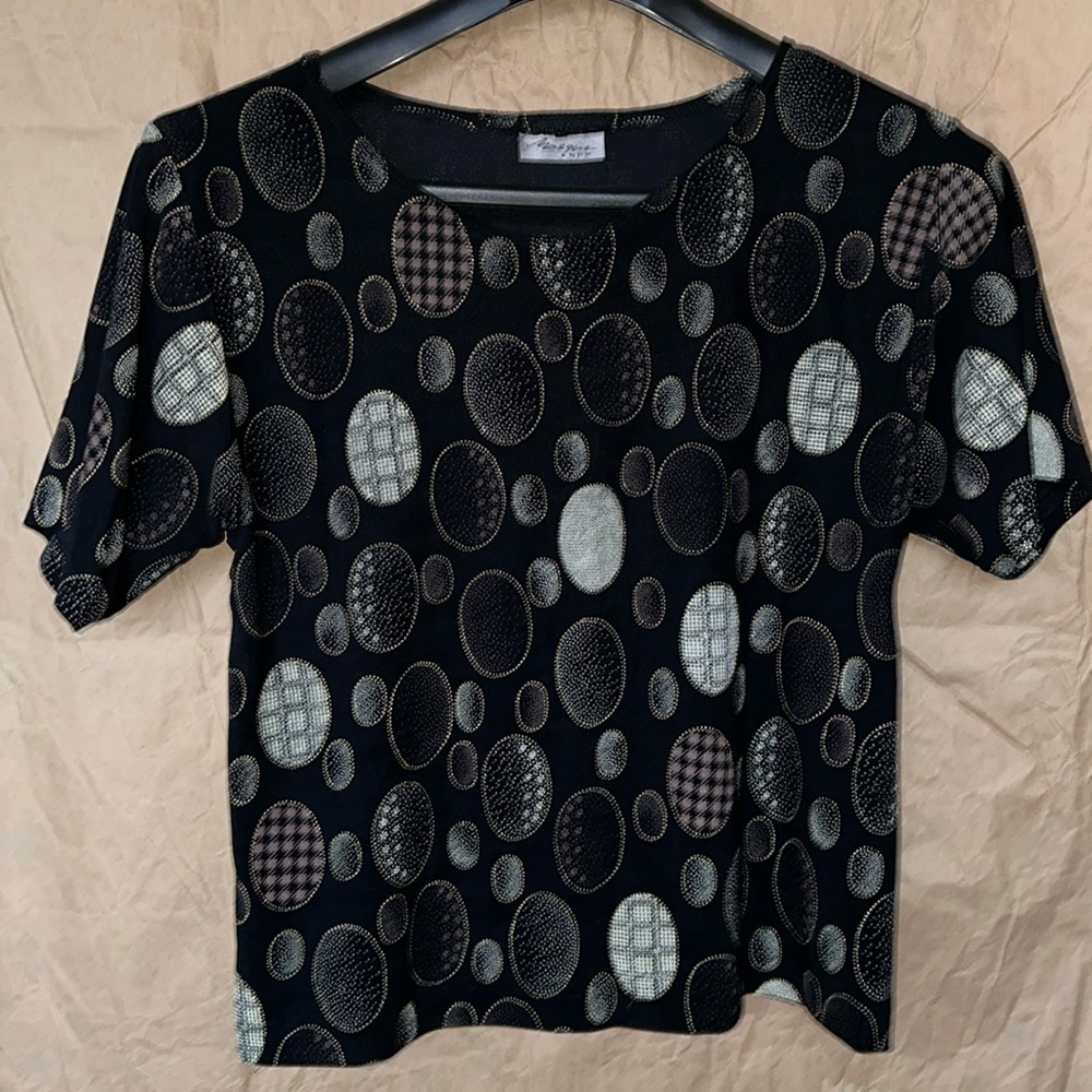 Black blouse with decorative ovals.